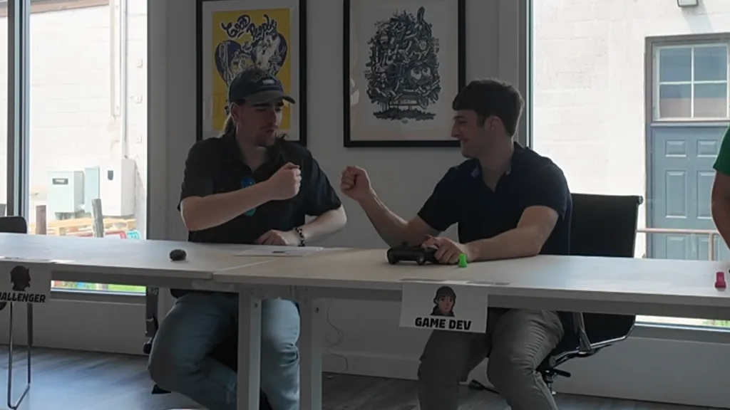 Two people playing Devoid at a table during the high-score challenge
