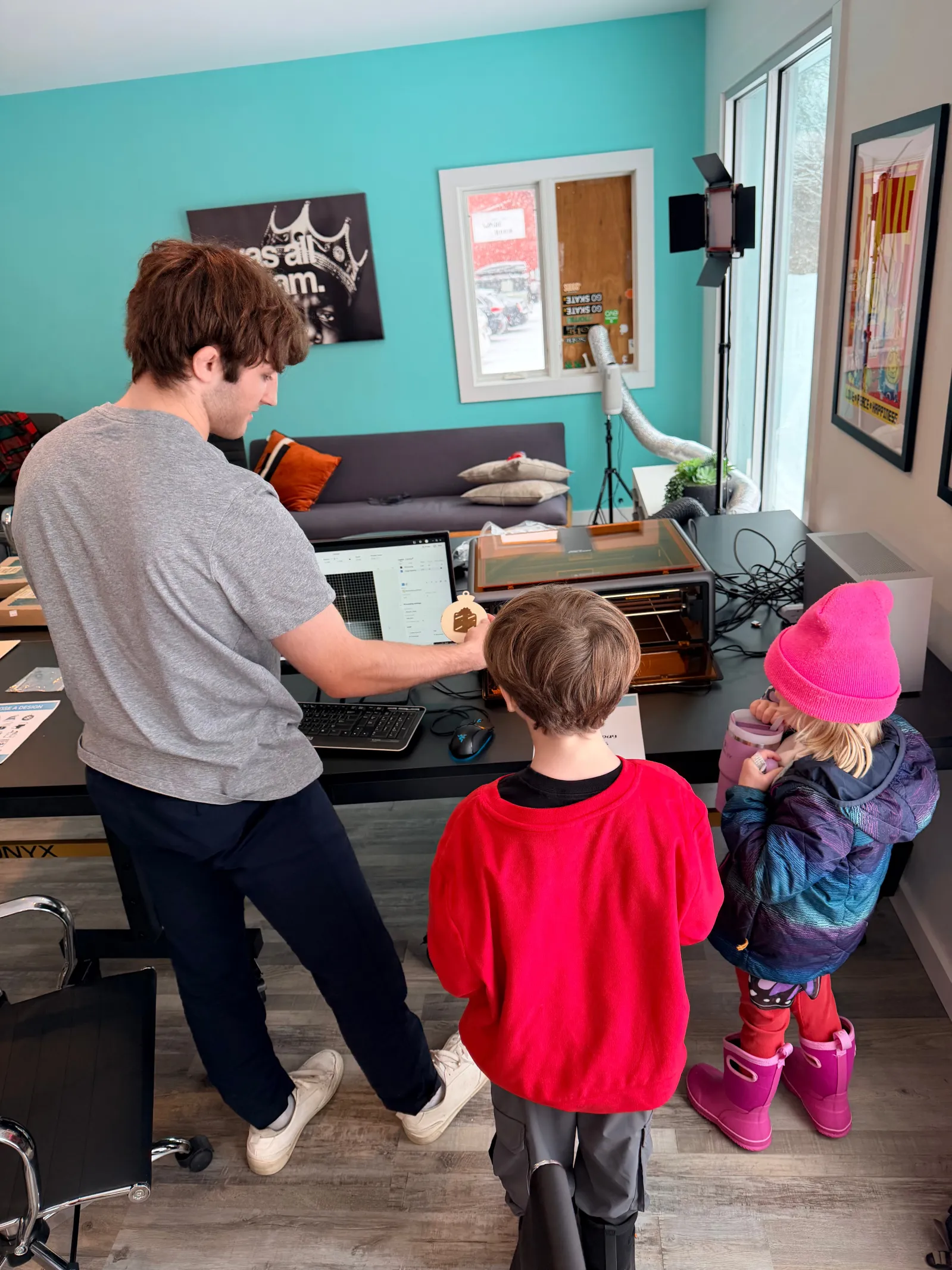 A laser cutter etching wooden ornaments at The Valley Hub
